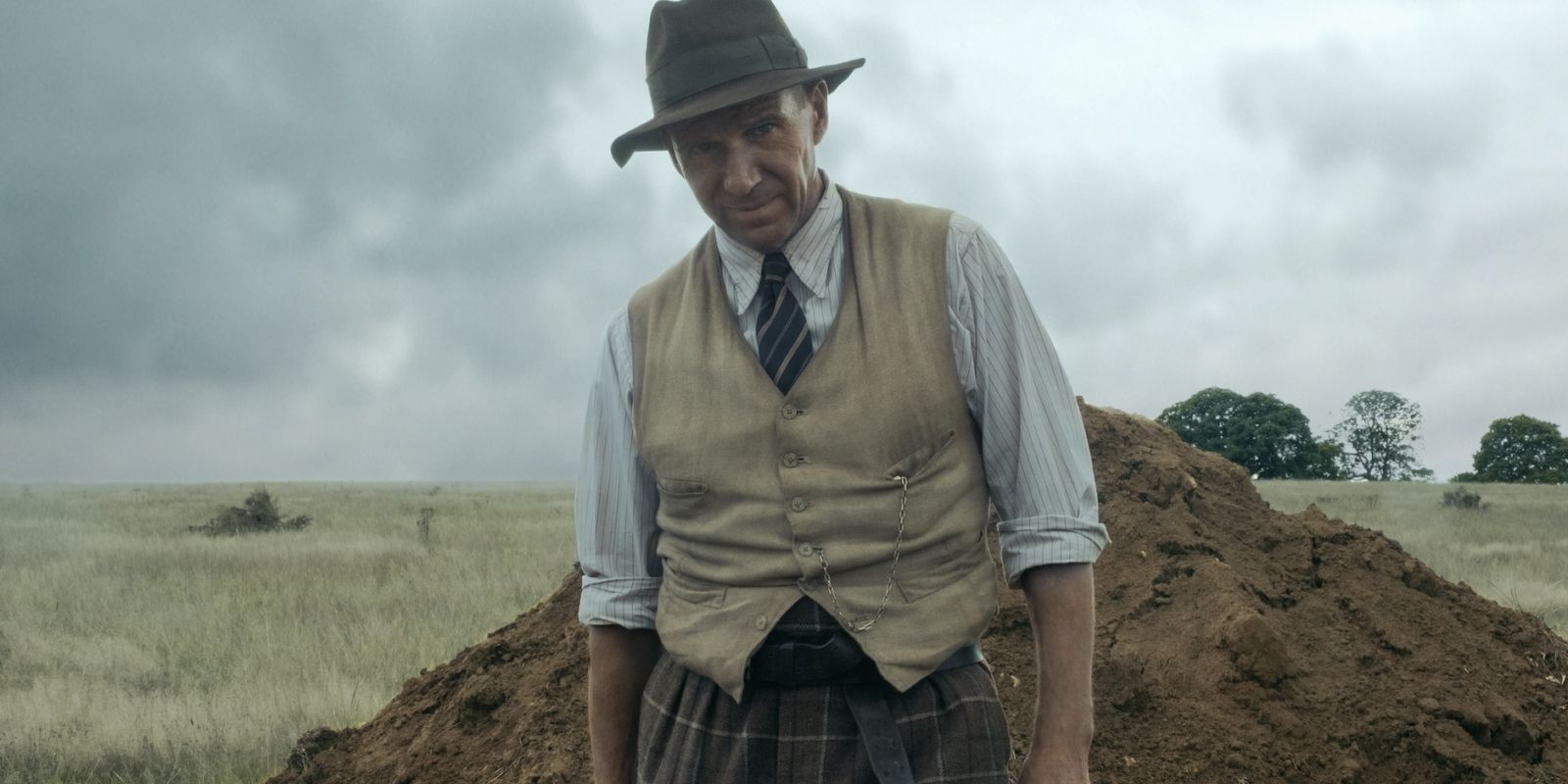 Basil Brown (Ralph Fiennes) standing outside in &lsquo;The Dig&rsquo;