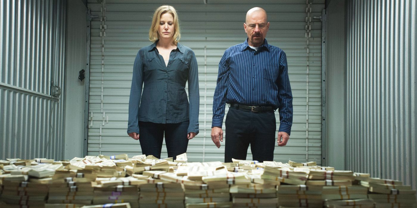 Skyler and Walter White looking down at a pile of money in a storage unit in Breaking Bad.