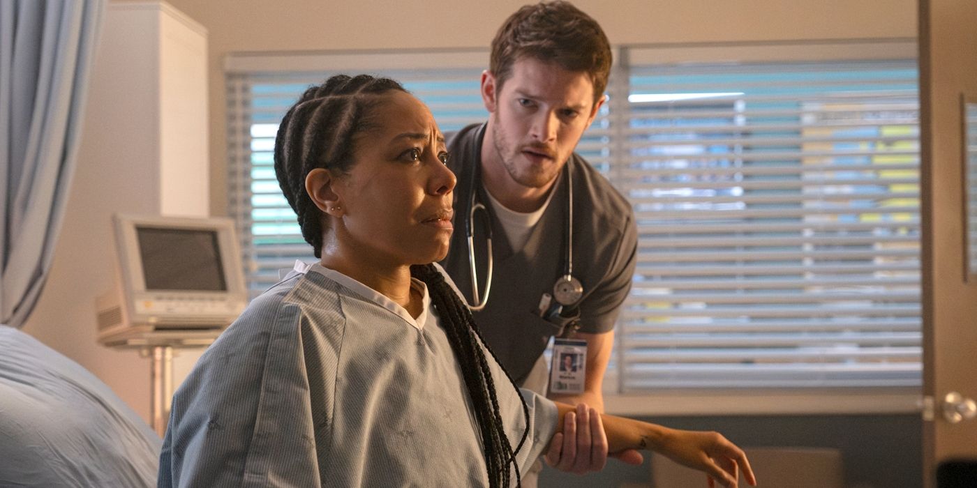 Jessie in a hospital gown, sits up, with Van holding onto her arm in a scene from Season 1, Episode 2 of 'Brilliant Minds.'