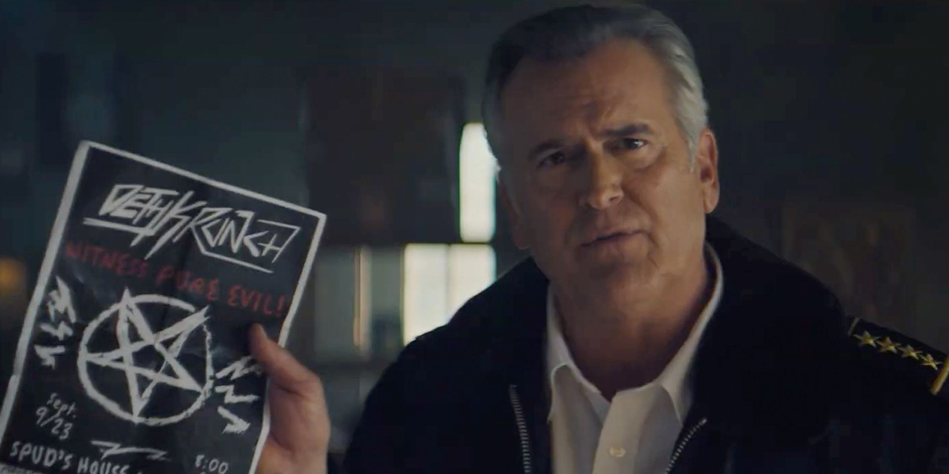 Bruce Campbell holding a flyer in Hysteria!