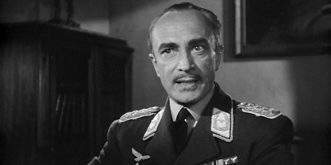 Major Heinrich Strasser sits in his Nazi uniform, glaring intensely as he interrogates someone in 'Casablanca' (1942).