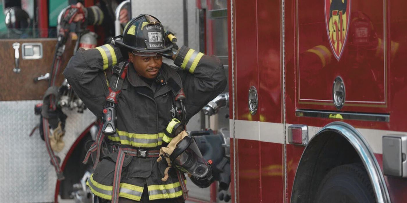 Firefighter Darren Ritter (Daniel Kyri) adjusts his helmet and gear next to a fire truck