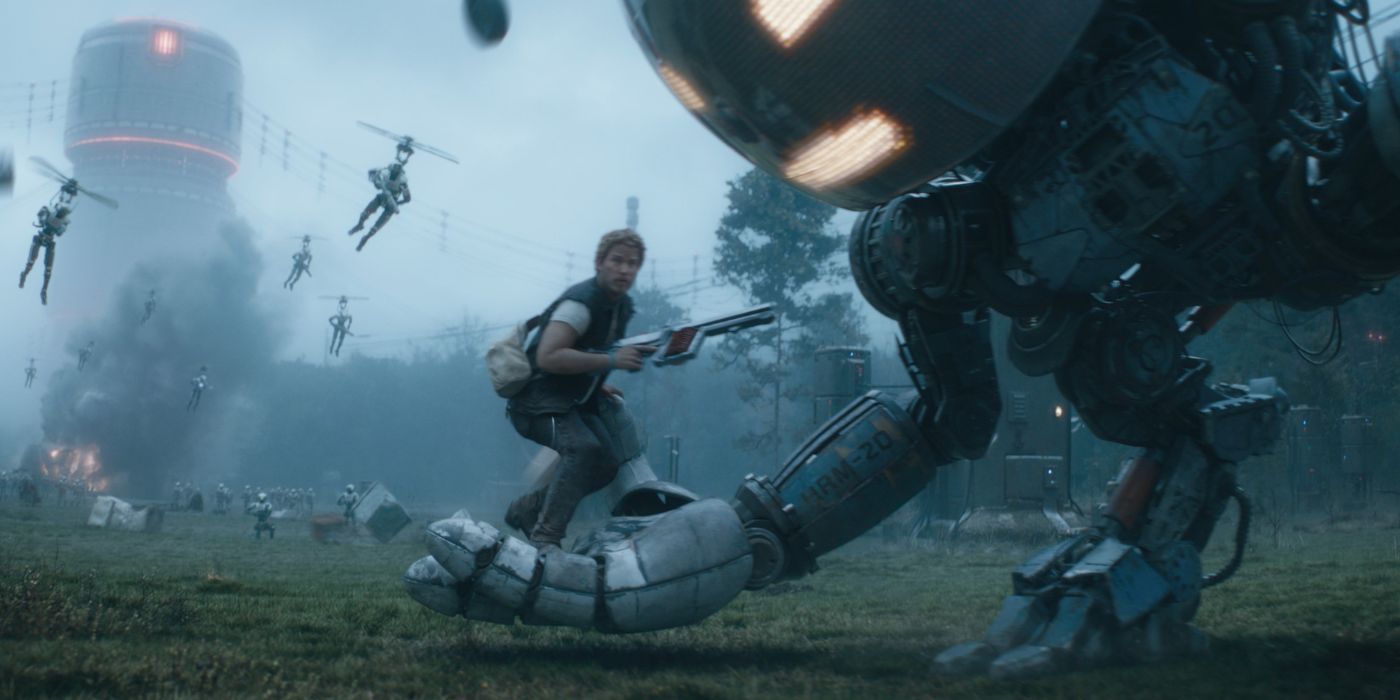 Chris Pratt holding a gun and standing on a giant robot's hand in The Electric State.