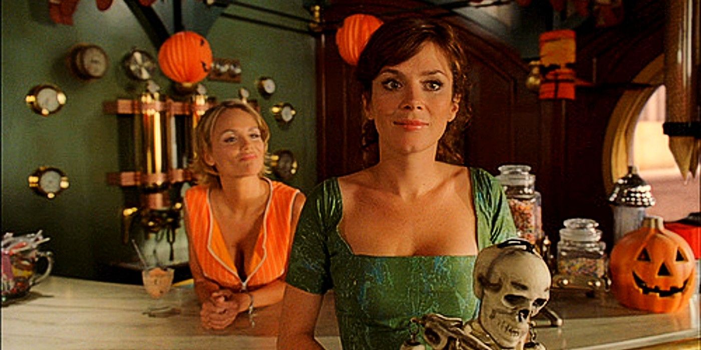 Olive and Chuck standing at the counter of The Pie Hole, which is decorated for Halloween in Pushing Daisies