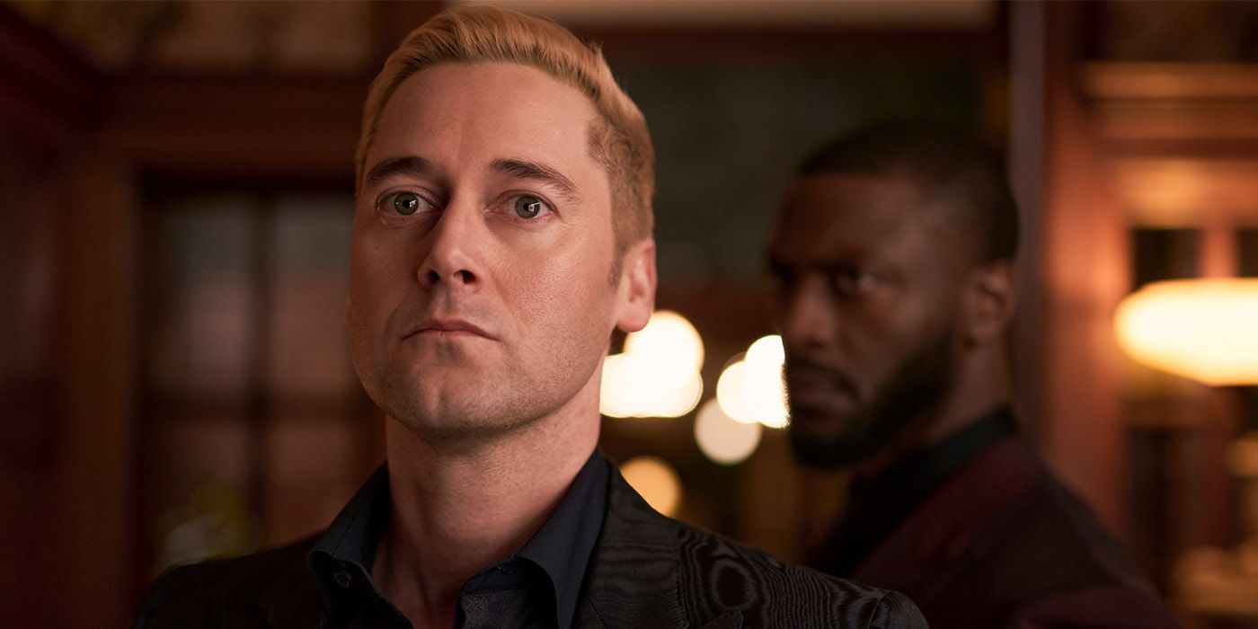 Ryan Eggold as Ed with blonde hair in a black shirt staring ahead with intensity