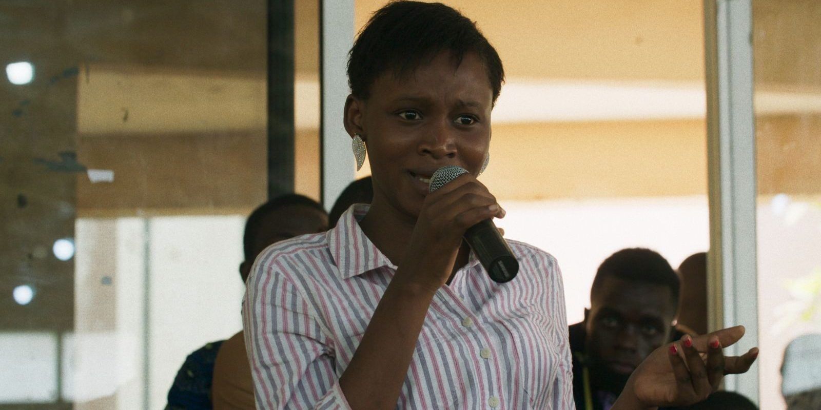 Woman speaking into a microphone in Dahomey Documentary