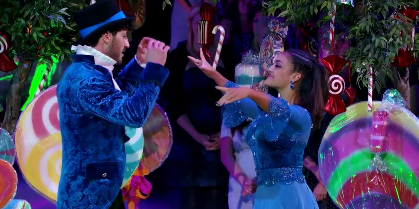 Laurie Hernandez & Val Chmerkovskiy in Halloween costumes with candy set pieces on Dancing with the Stars.