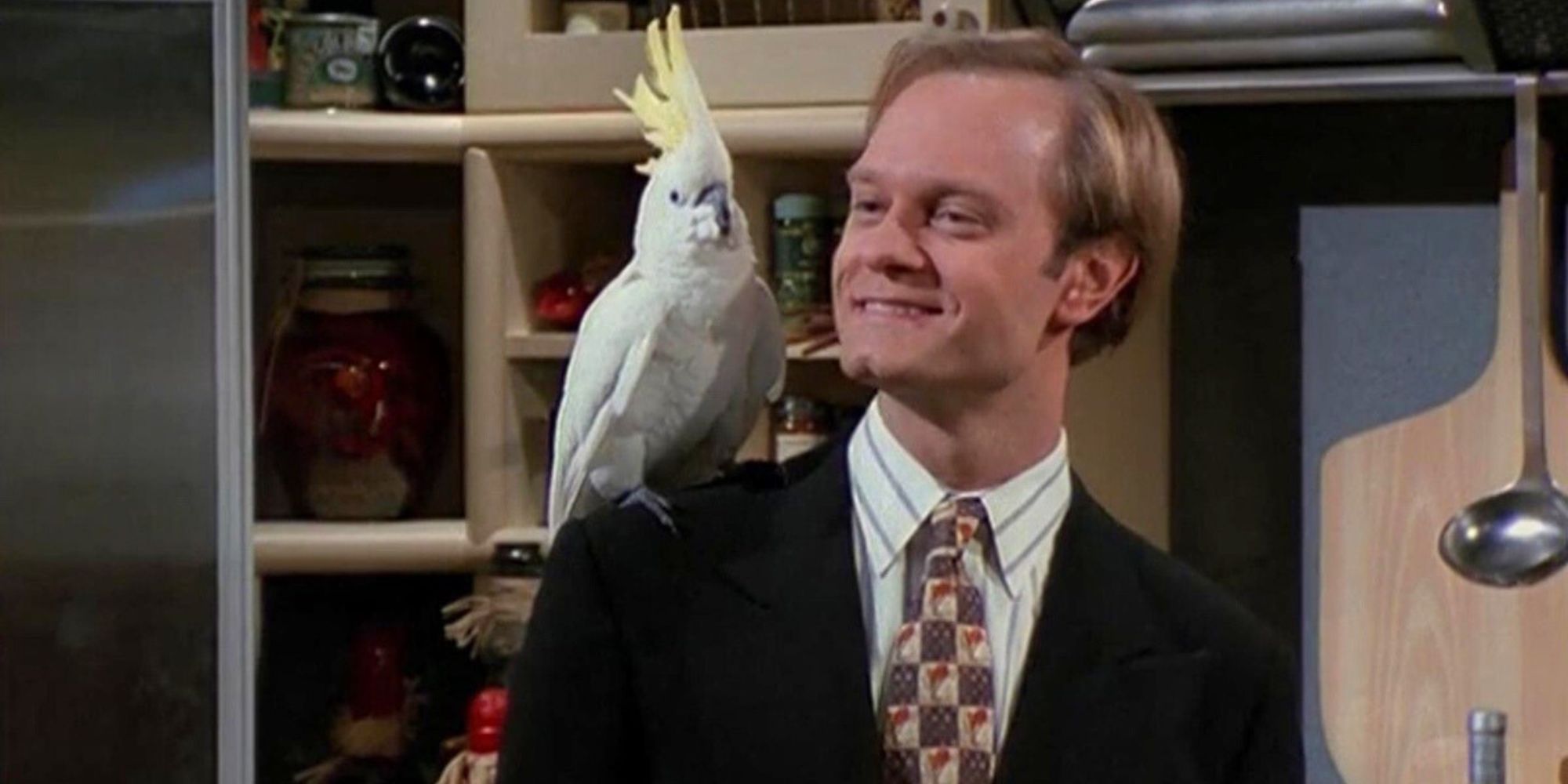 David Hyde Pierce with a white cockatoo on his shoulder in Frasier