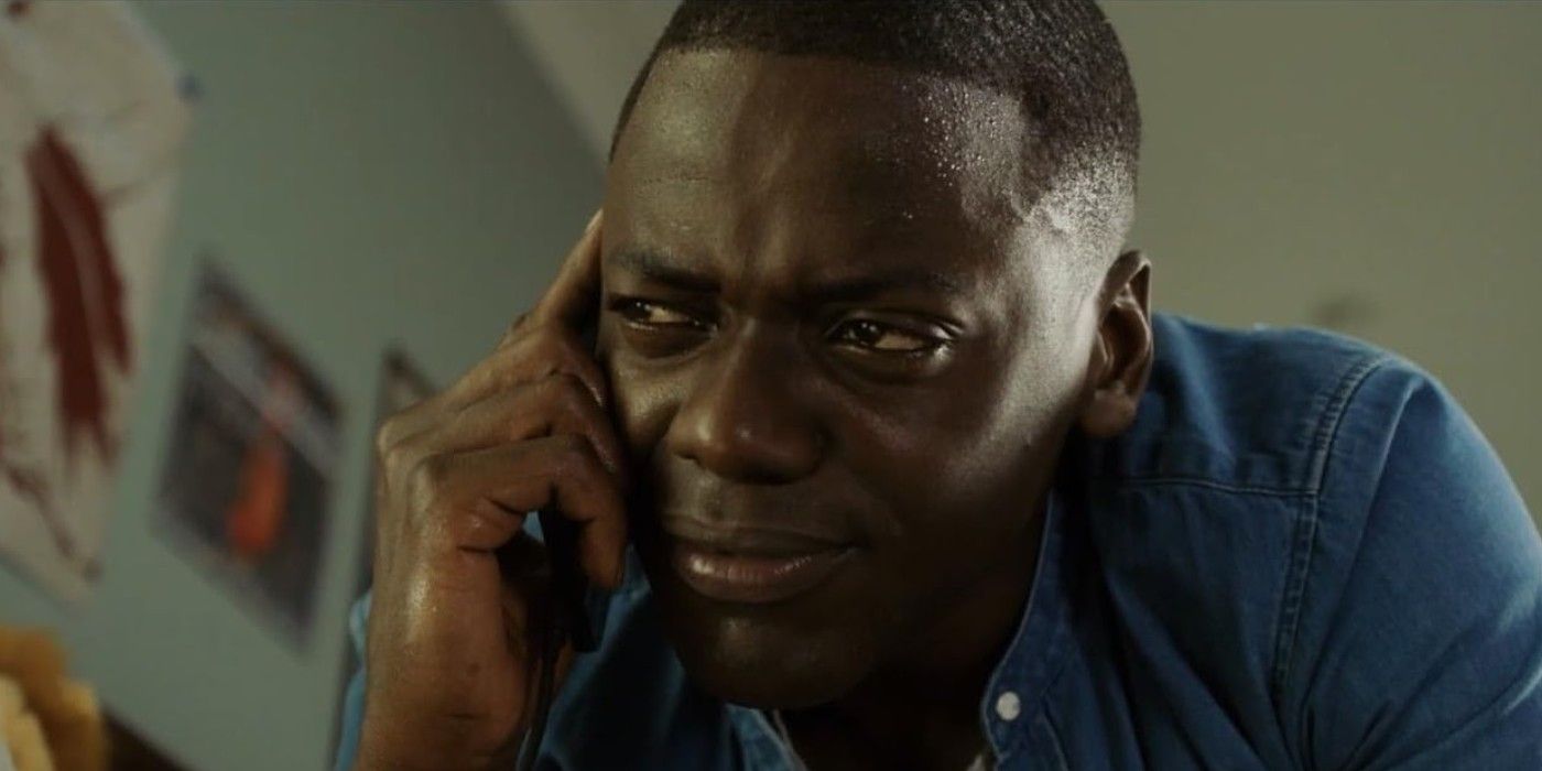 Daniel Kaluuya talking on a cell phone with a confused expression in 'Get Out'