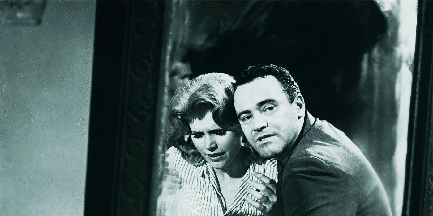 A man holding a distraught woman while looking in the mirror in Days of Wine and Roses