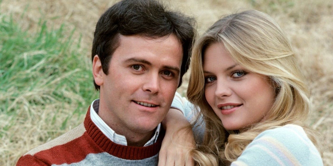 Otter smiles as Michelle Pfeiffer as &ldquo;The Bombshell&rdquo; cuddles close in a promo photo for Delta House.