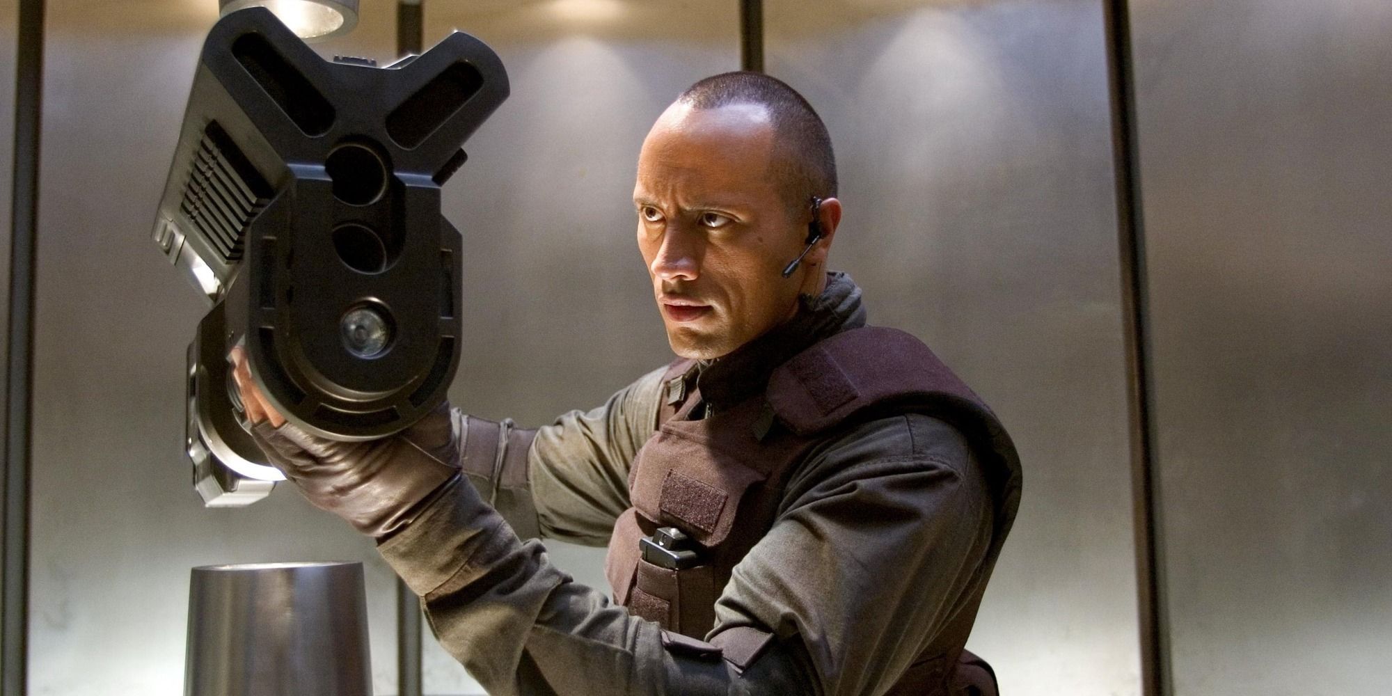 Dwayne Johnson as Sarge holding the BFG weapon in 'Doom' (2005)