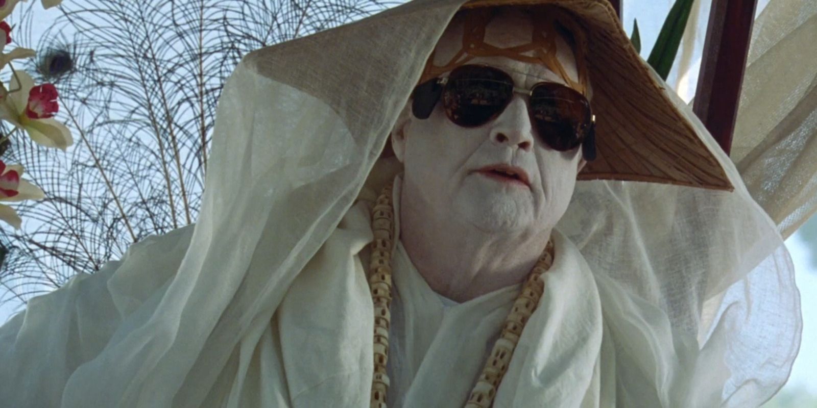 Dr. Moreau, played by actor Marlon Brando, in “The Island of Dr. Moreau” a white ceremonial robe with matching face paint and sunglasses