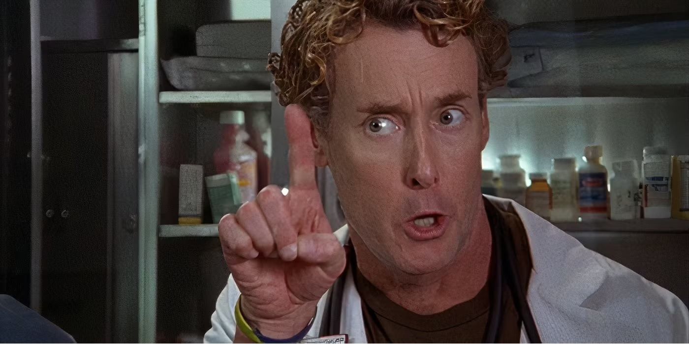 Dr. Perry Cox shakes his finger and scolds someone off camera in Scrubs.