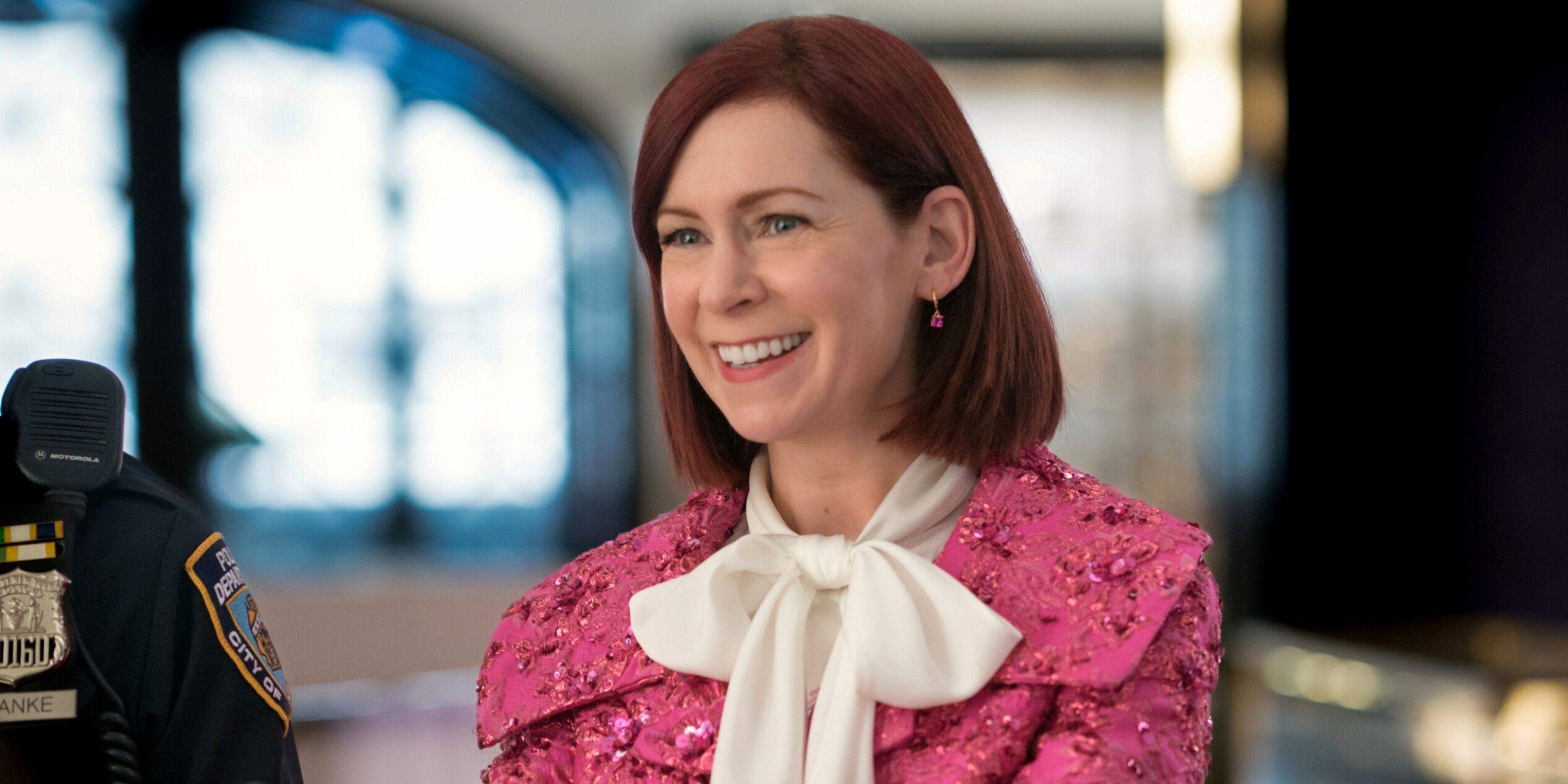 Carrie Preston as Elsbeth Tascioni in a pink jacket and white blouse with a big bow in Season 2 of Elsbeth