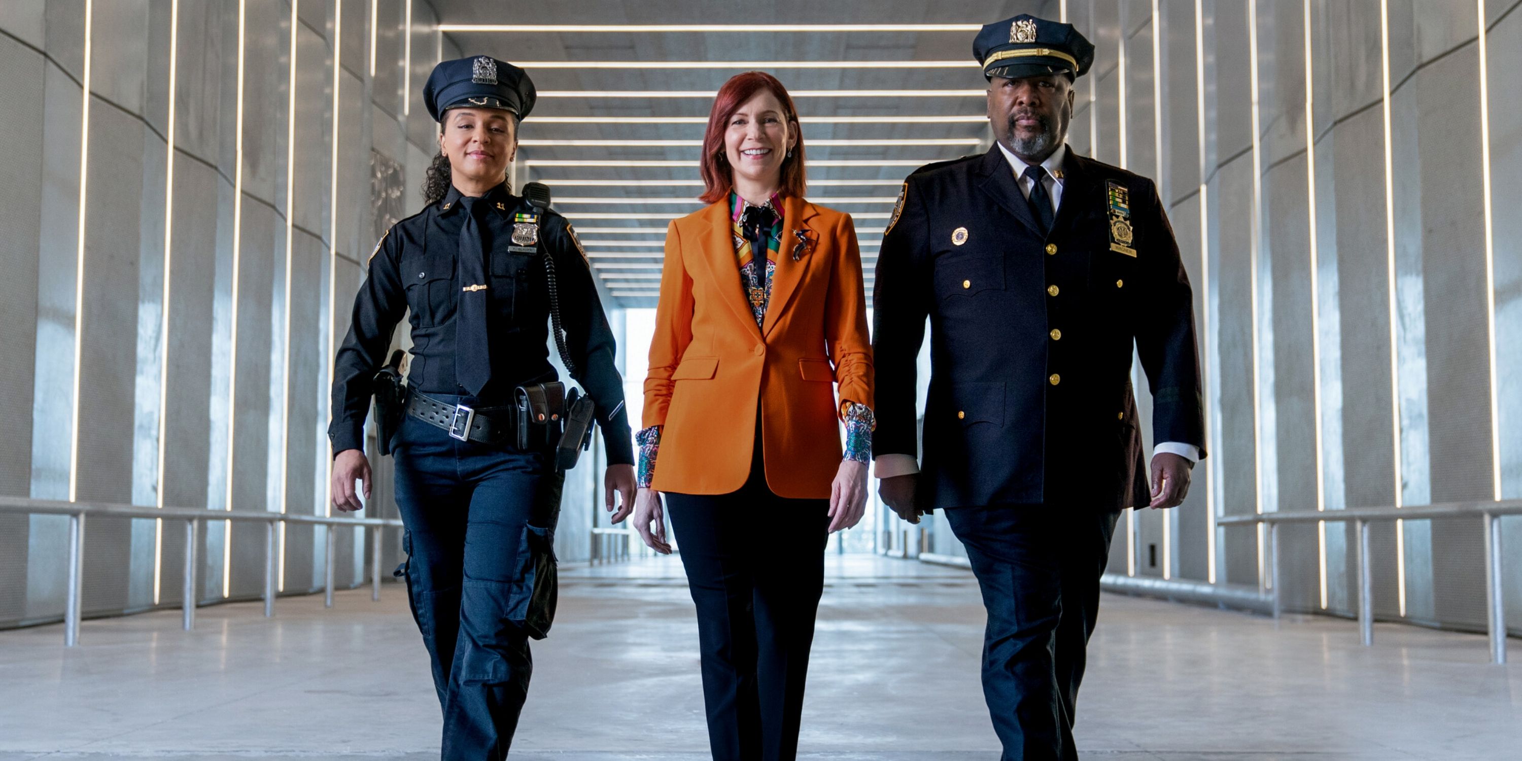 Carrie Preston as Elsbeth Tascioni walking down a hall with Wendell Pierce and Carra Patterson in Elsbeth