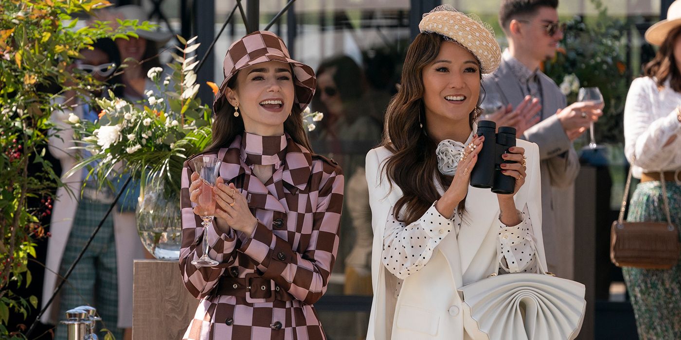 Emily and Mindy clapping in regal outfits in Emily in Paris