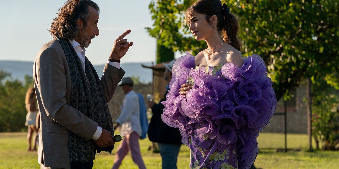 Emily talking to Laurent in Emily in Paris wearing a purple flowery dress.