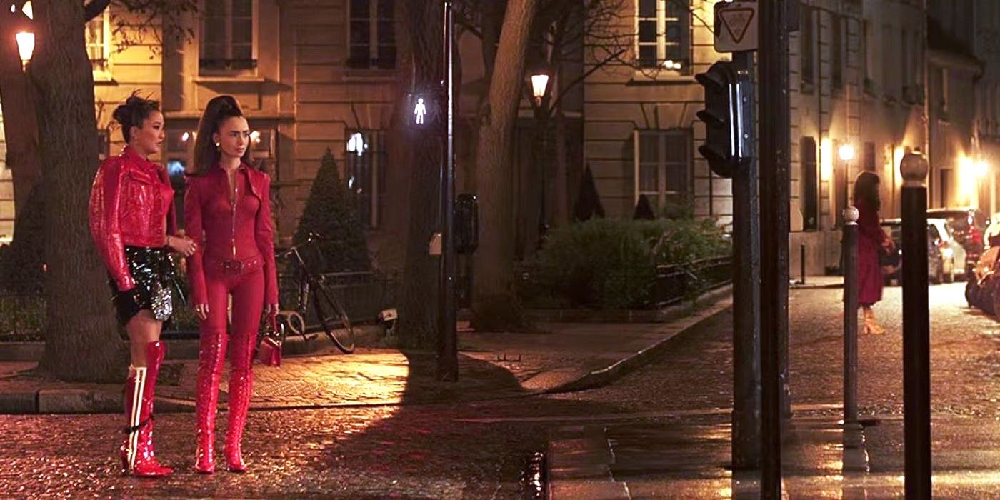 Emily wearing a red bodysuit and another person standing on a street at night in Emily in Paris.