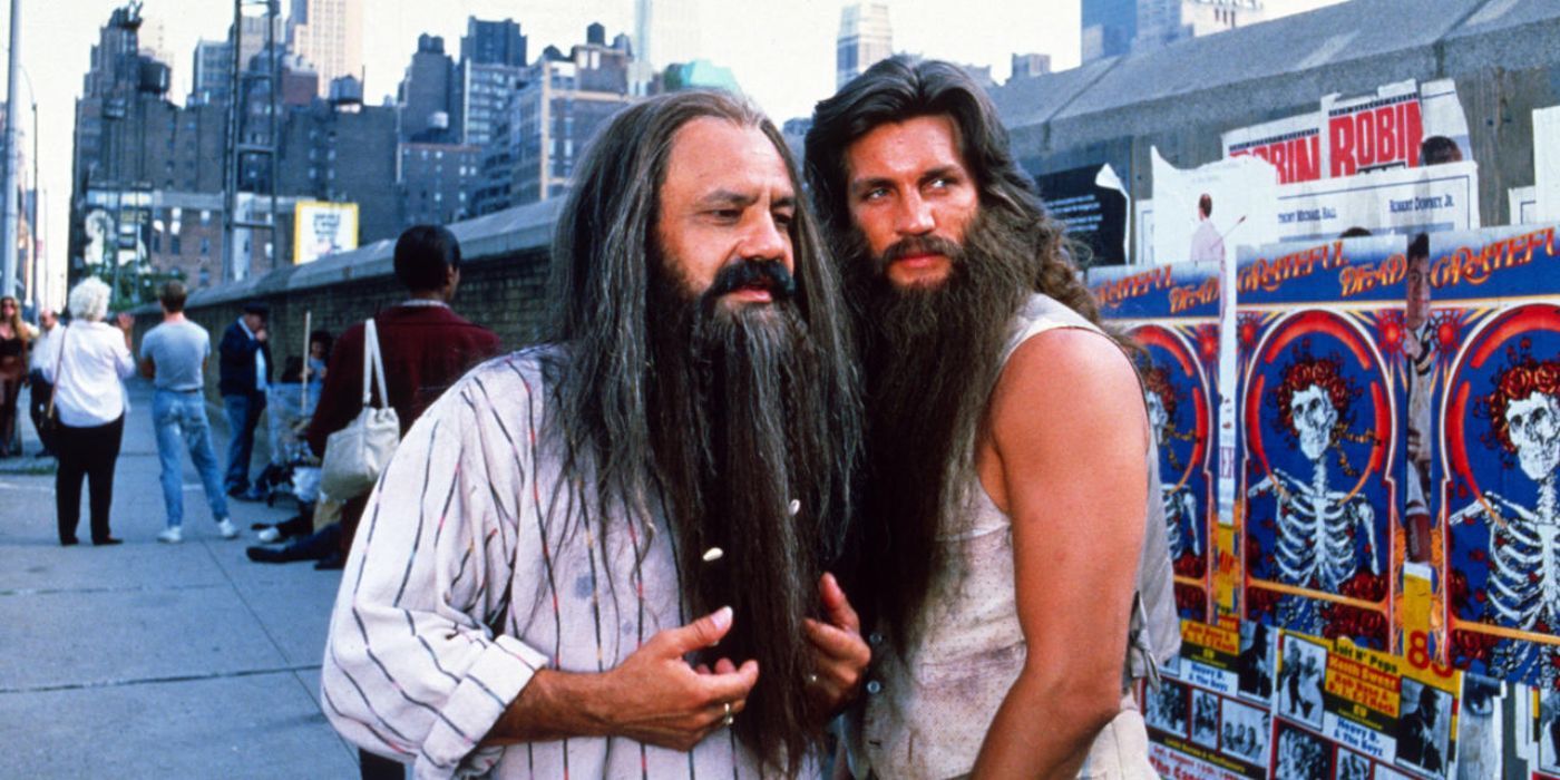 Two long bearded men stand on a New York sidewalk looking around