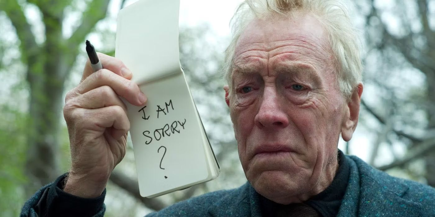 The Renter (Max von Sydow) holds up a notepad that reads "I AM SORRY?" while looking distraught and sad in 'Extremely Loud & Incredibly Close' (2011),