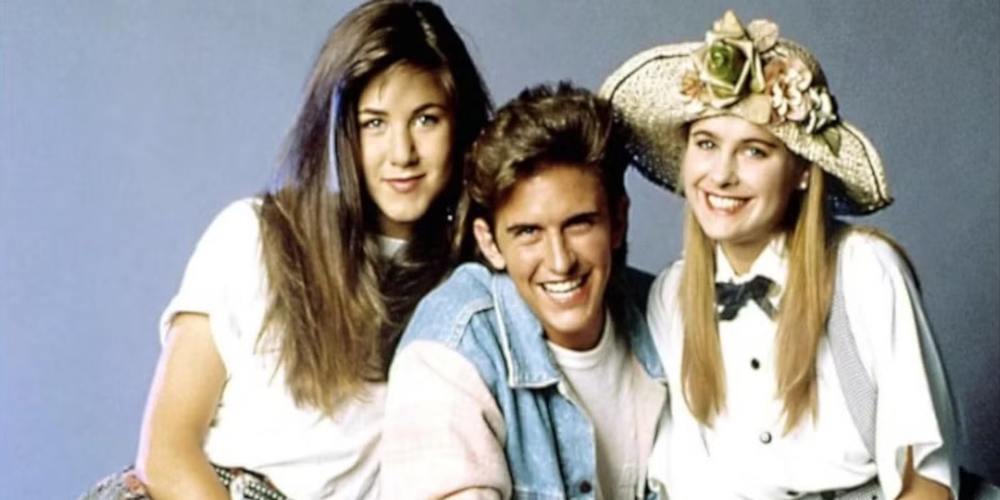 Ferris smiles for a photo next to Jeannie and Sloan for the television series, Ferris Bueller.