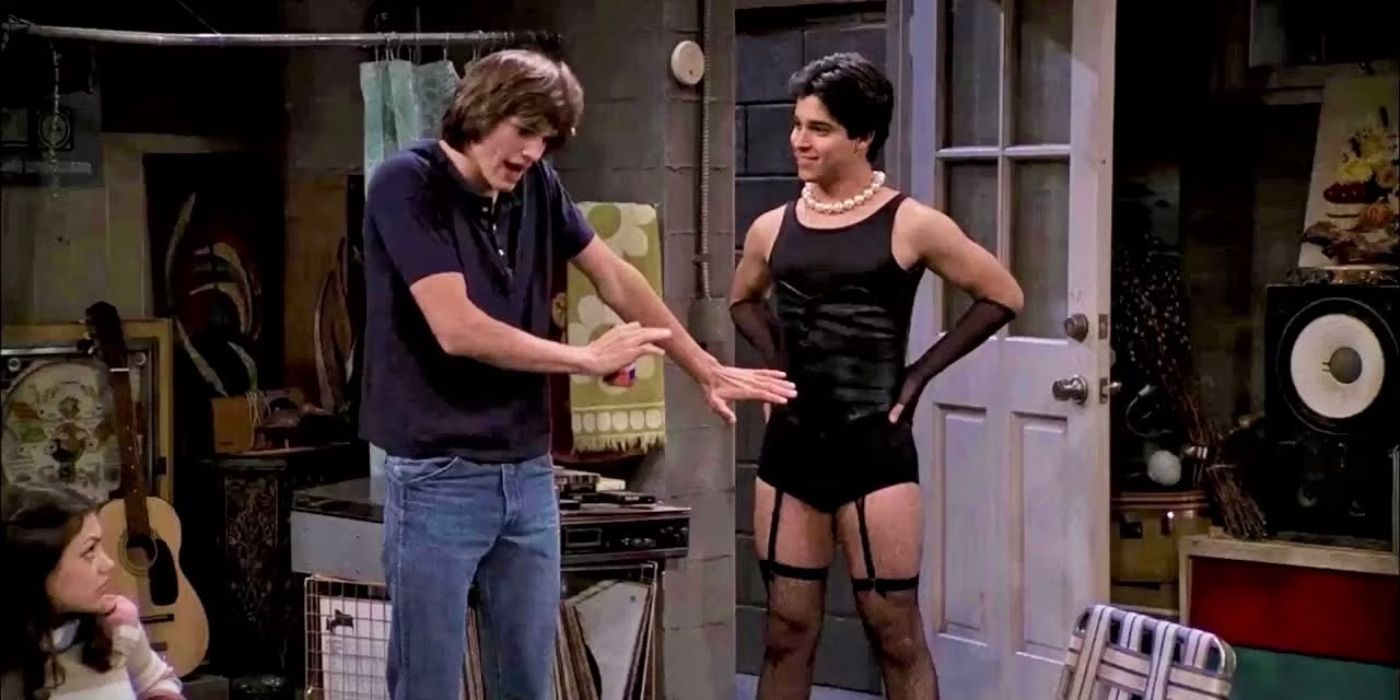 Kelso looks embarrassed as Fez stands proudly in a revealing Halloween costume on That 70s Show.