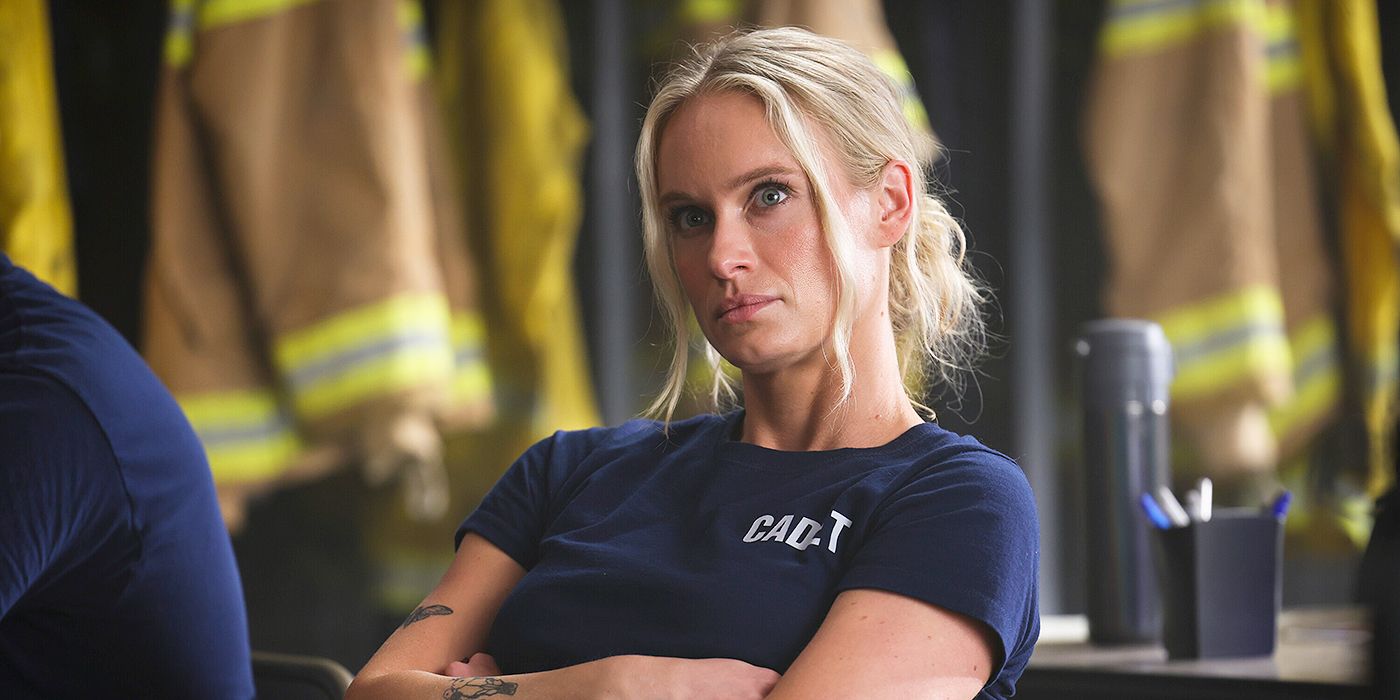 Audrey James sitting at a table with her arms crossed in her cadet t-shirt in Fire Country Season 3