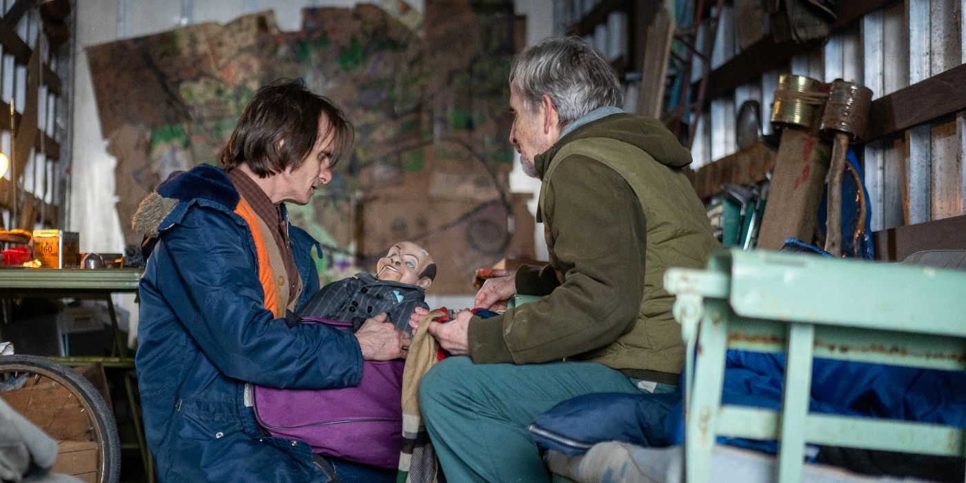 Scott McCord and Robert Joy looking at a puppet