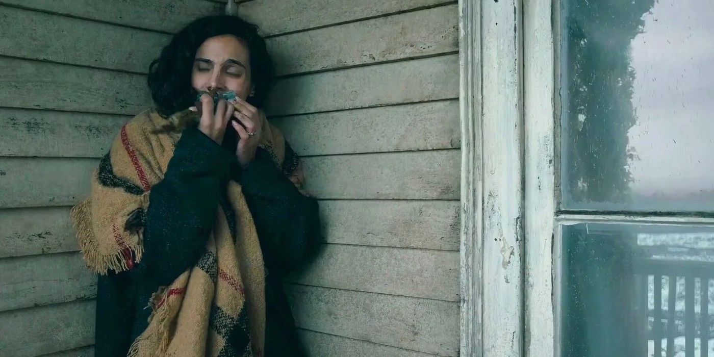 Fatima standing on a front porch smelling something in the TV show From