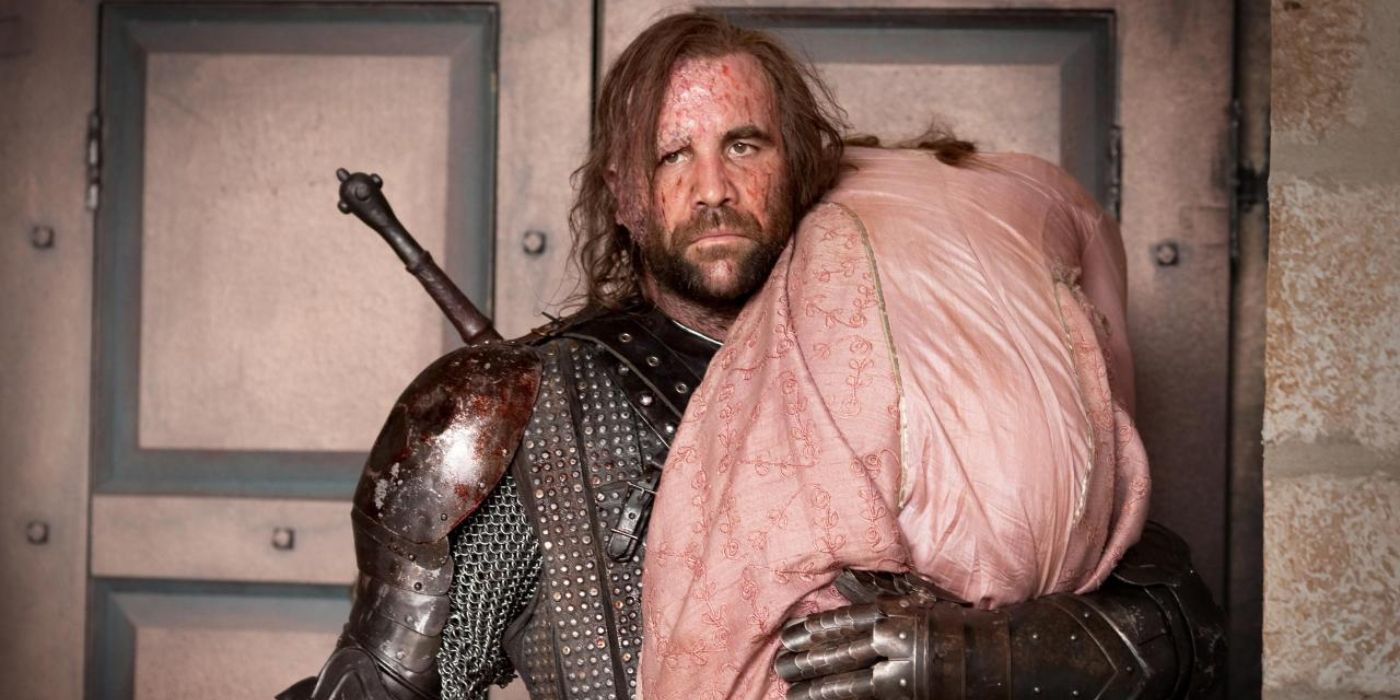 Sandor Clegane aka the Hound, carries an unconscious Sansa Stark over his shoulder as he rescues her from a riot in 'Game of Thrones' Season 2, Episode 6 "The Old Gods and the New"