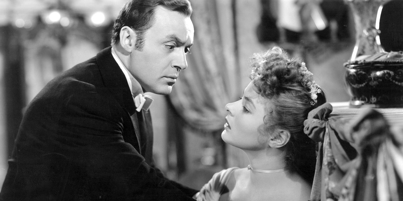 Gregory (Charles Boyer) looming threateningly over a seated and distresed-looking Paula (Ingrid Bergman) in Gaslight