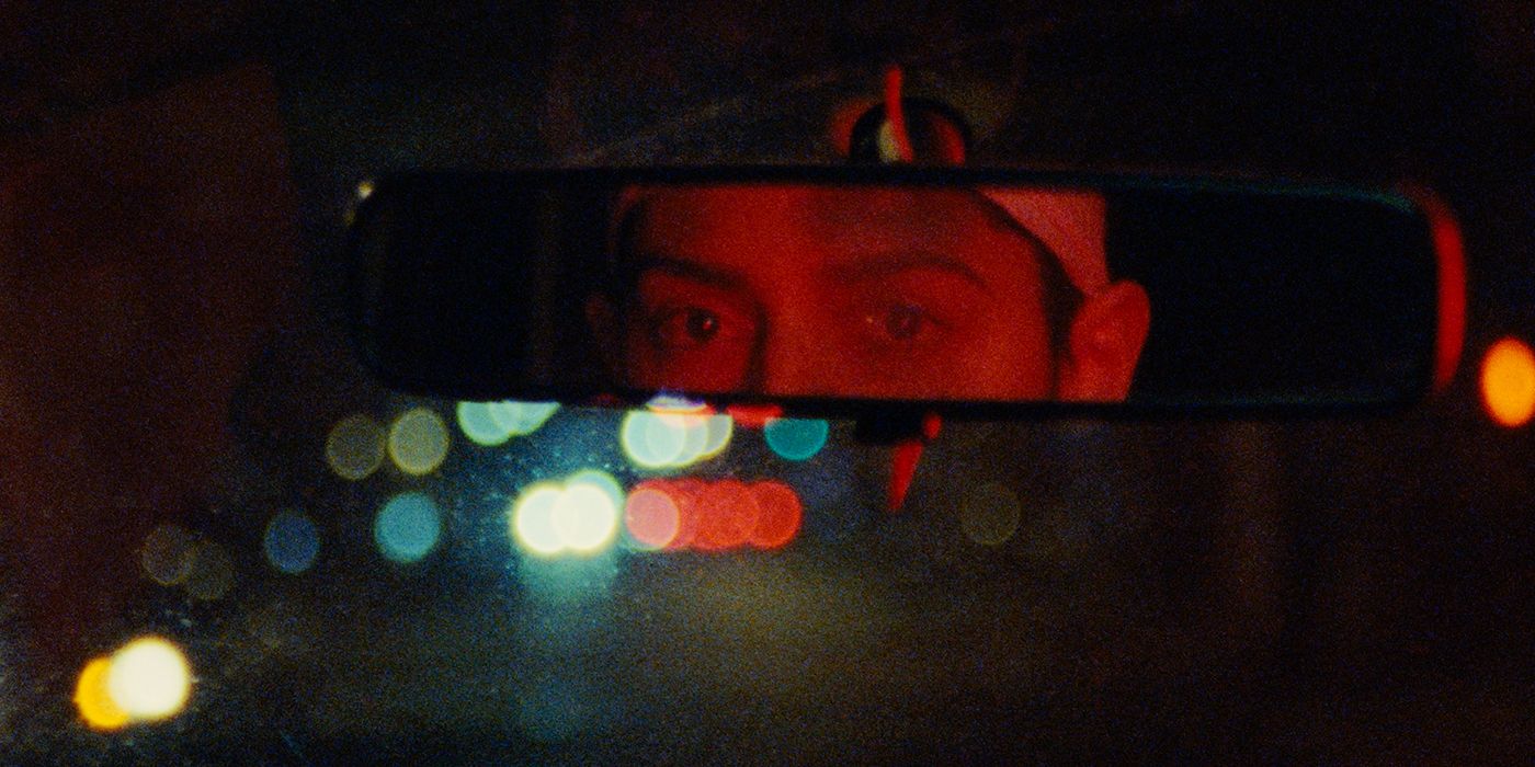 Ariella Mastroianni looking into a rearview mirror in red lighting in Gazer