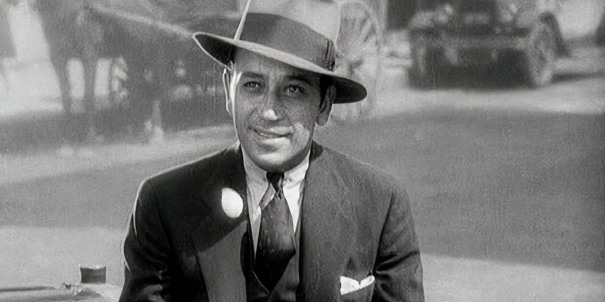 George Raft smiling and looking ahead in Scarface (1932)