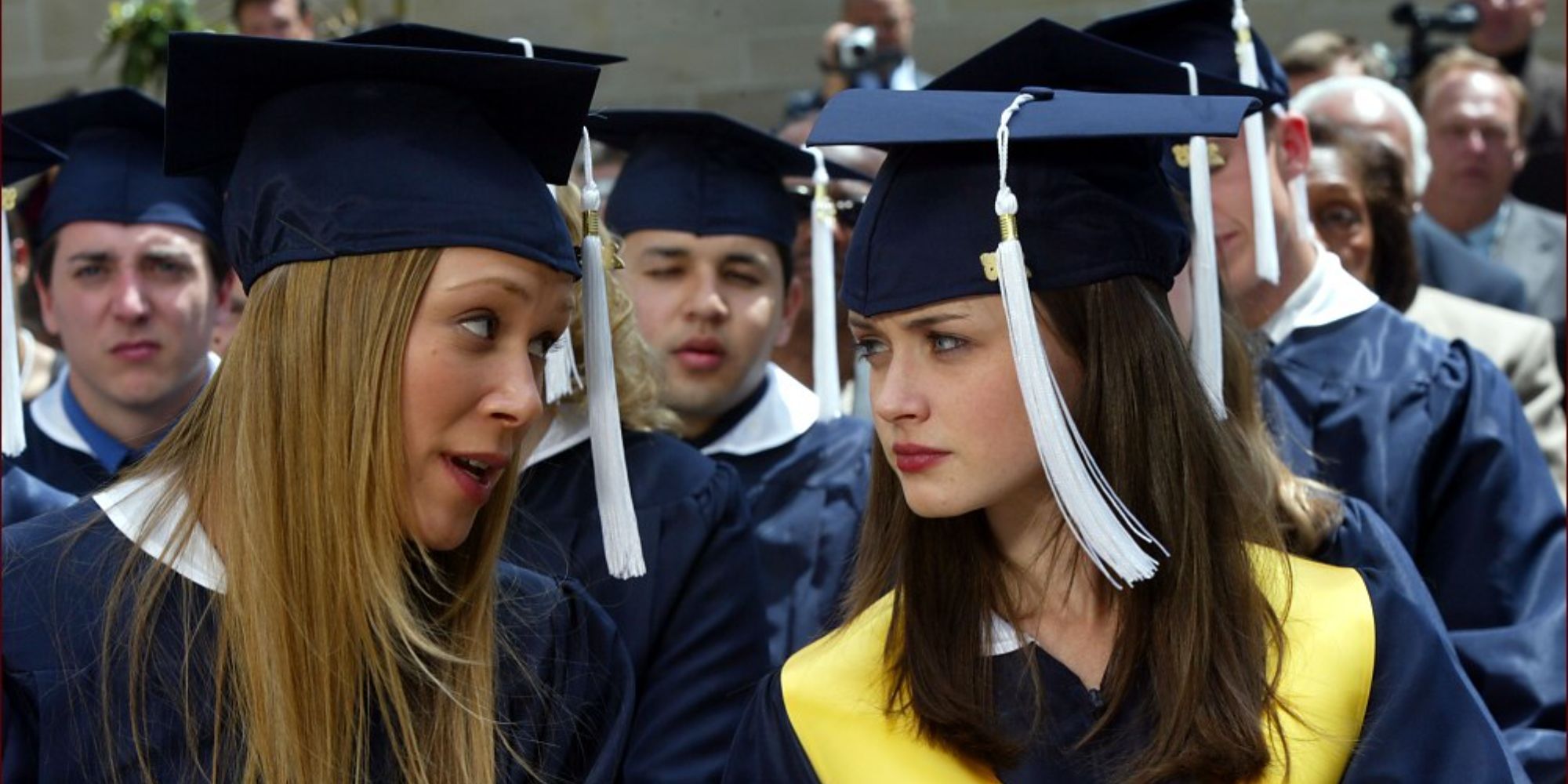 Rory (Alexis Bledel) and Paris (Liza Weil) wearing graduation clothes in Gilmore Girls