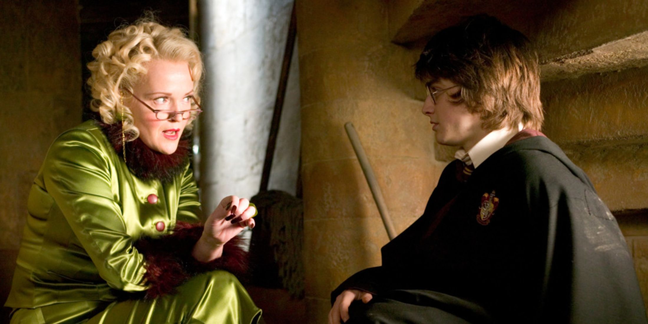 Rita Skeeter, played by actor Miranda Richardson, sits in a stairwell with Harry, played by actor Daniel Radcliffe, in Harry Potter and the Goblet of Fire.