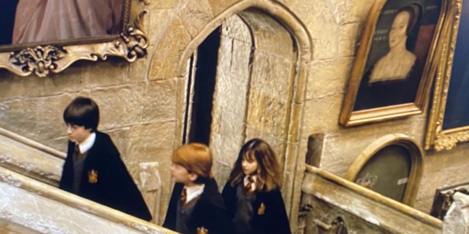 Harry, Ron, and Hermione climbing the stairs in Harry Potter and the Sorcerer&rsquo;s Stone