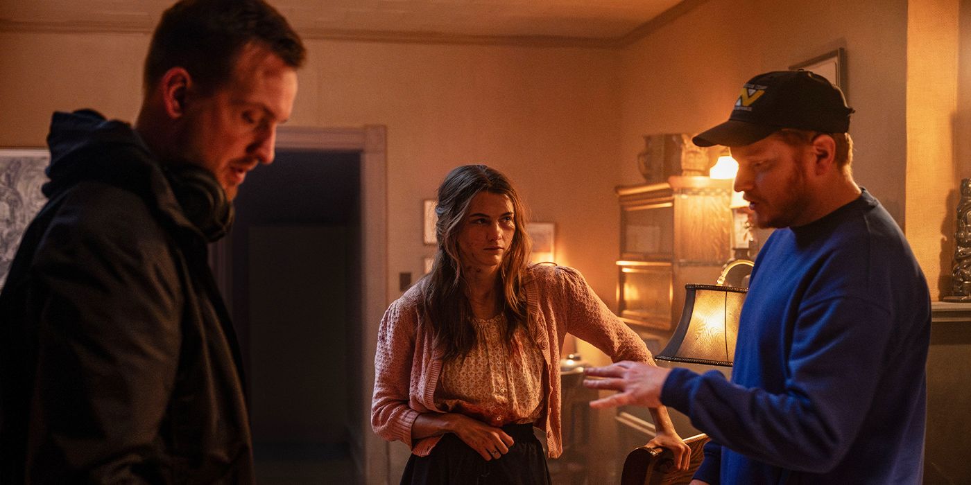 Directors Scott Beck and Bryan Woods explaining something to Chloe East on the set of Heretic