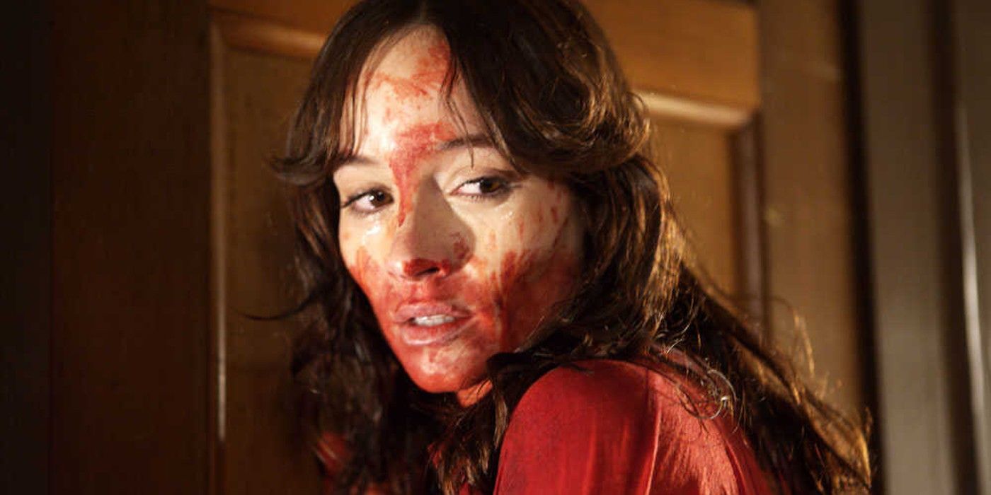 Samantha, covered in blood, looks over her shoulder in Ti West's horror The House of the Devil