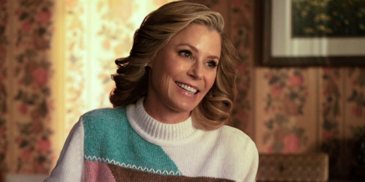 Julie Bowen as Linda smiling big in a white turtleneck with color blocking in Hysteria!