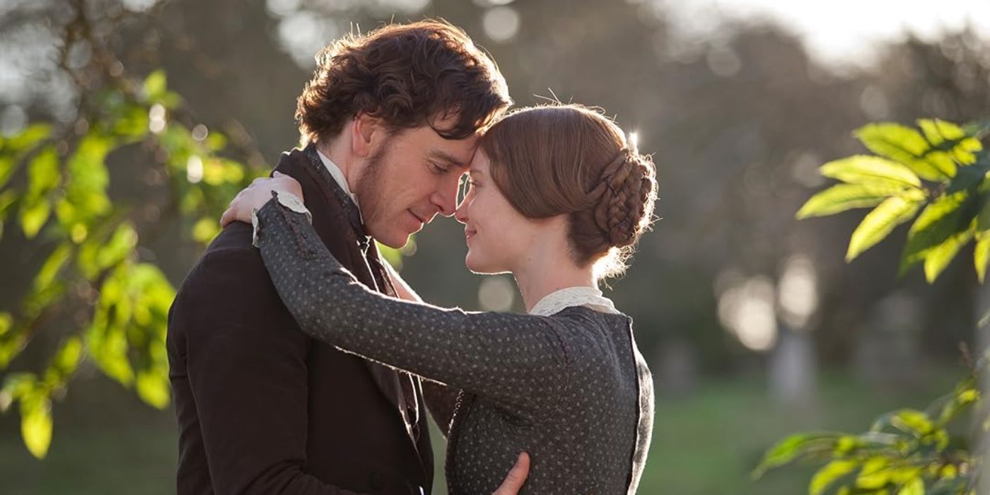 Edward (Michael Fassbender) &amp; Jane (Mia Wasikowska) hold each other in their arms in Jane Eyre.