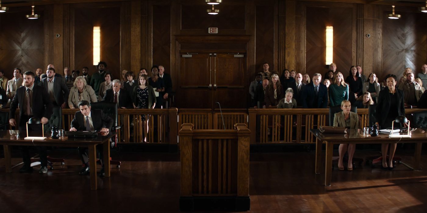 Gabriel Basso, Chris Messina, and Toni Collette standing up in a courtroom in Juror No. 2