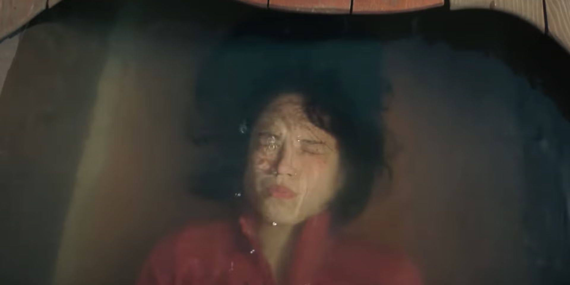 Kelsey Asbille as Iris, laying in a boat filled with water and holding her breath in Don&rsquo;t Move