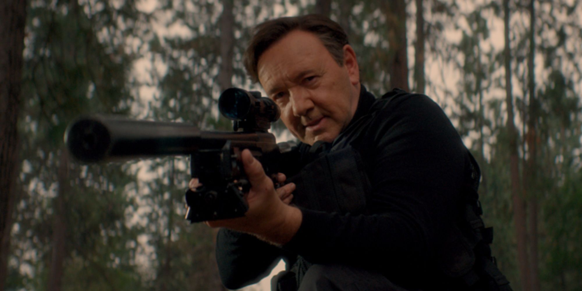 Kevin Spacey pointing a sniper rifle at the camera in &lsquo;Peter Five Eight&rsquo;