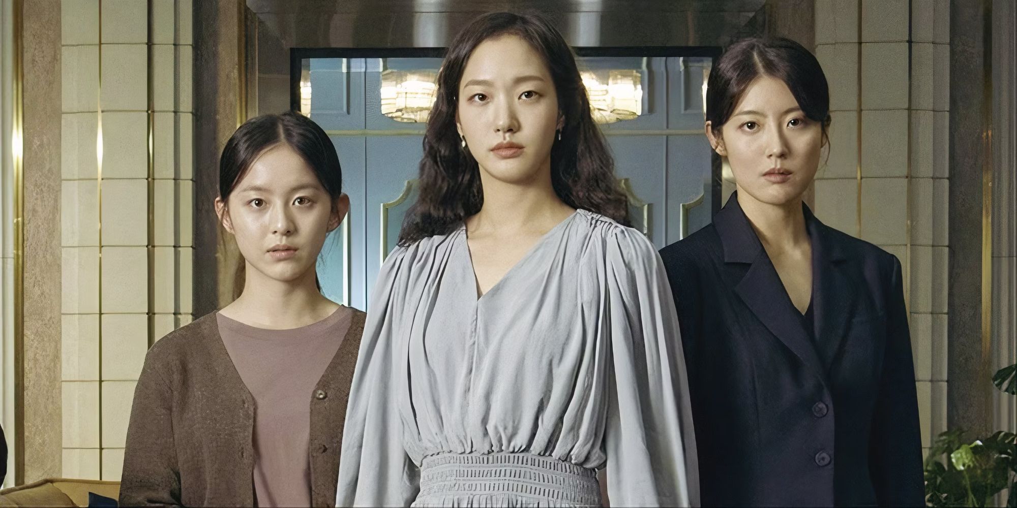 Three women standing together looking at the camera in the Korean drama Little Women. 