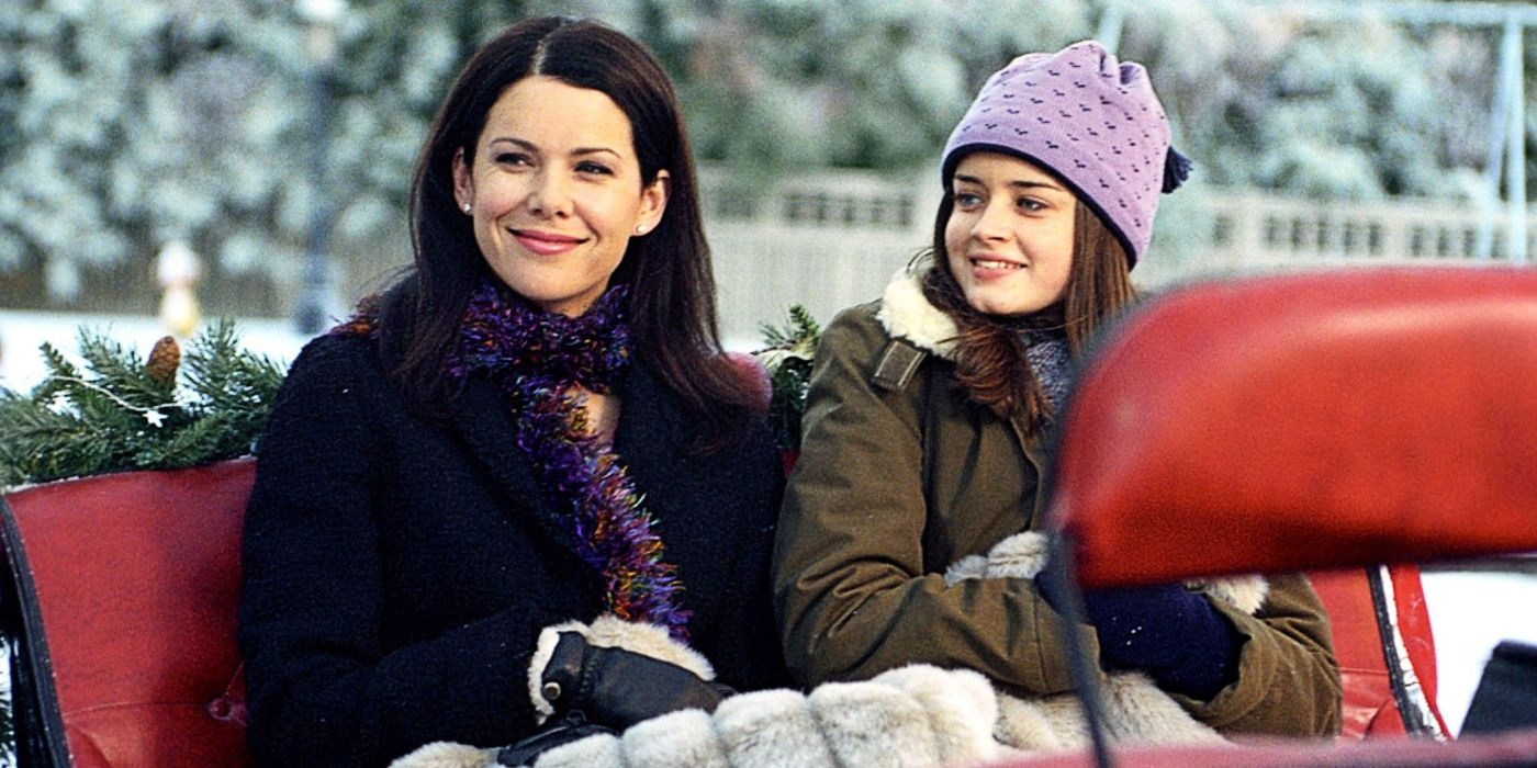 Lorelai and Rory ride in a carriage with blankets and snow in the background on Gilmore Girls.