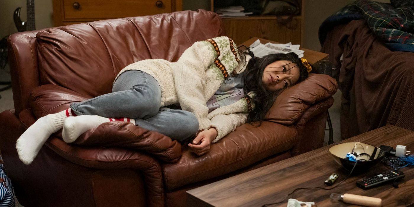 Stephanie Hsu lays on a leather couch looking very sad in &lsquo;Laid&rsquo;.