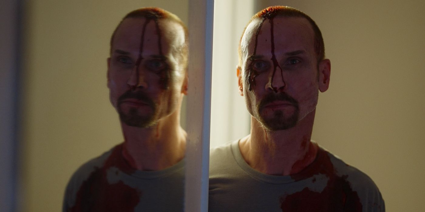 colin cunningham stands with blood running down his face in 'He Never Left'