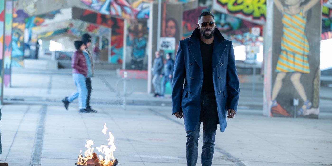 coleman domingo looks so cool wearing shades and a dark jacket while walking by a fire in 'The Madness'