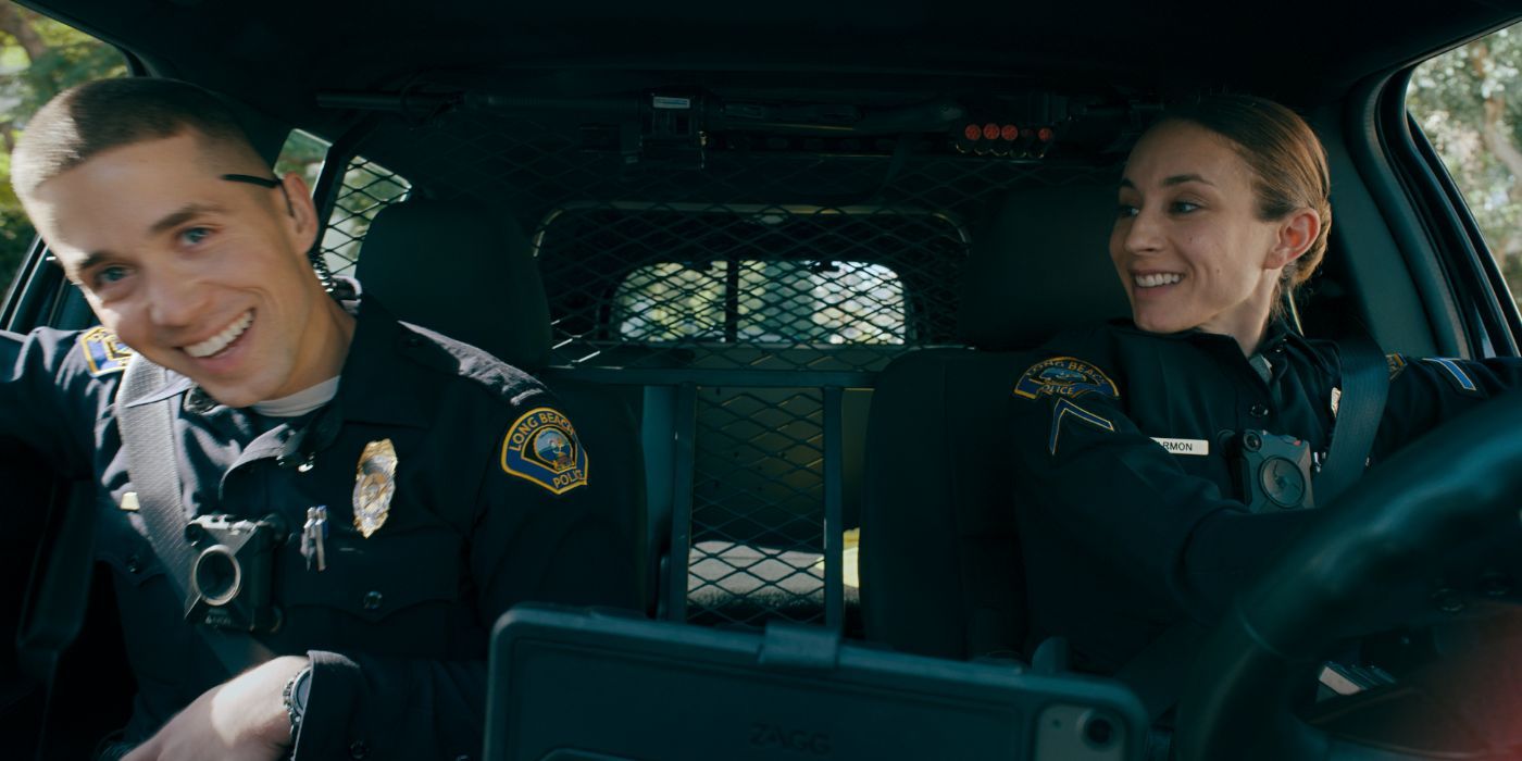 Brandon Larracuente and Troian Bellisario as two police officers in 'On Call' goofing off in their car